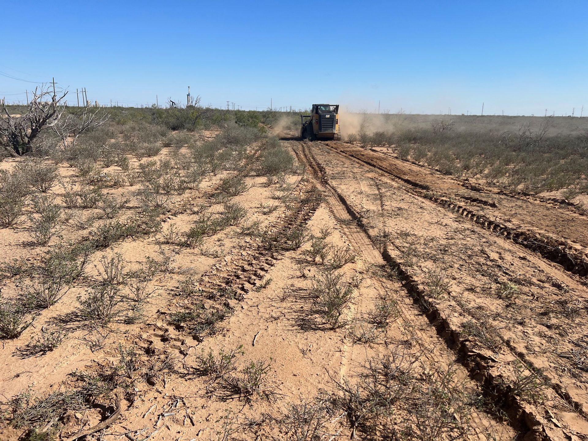 A truck is driving down a dirt road in the desert