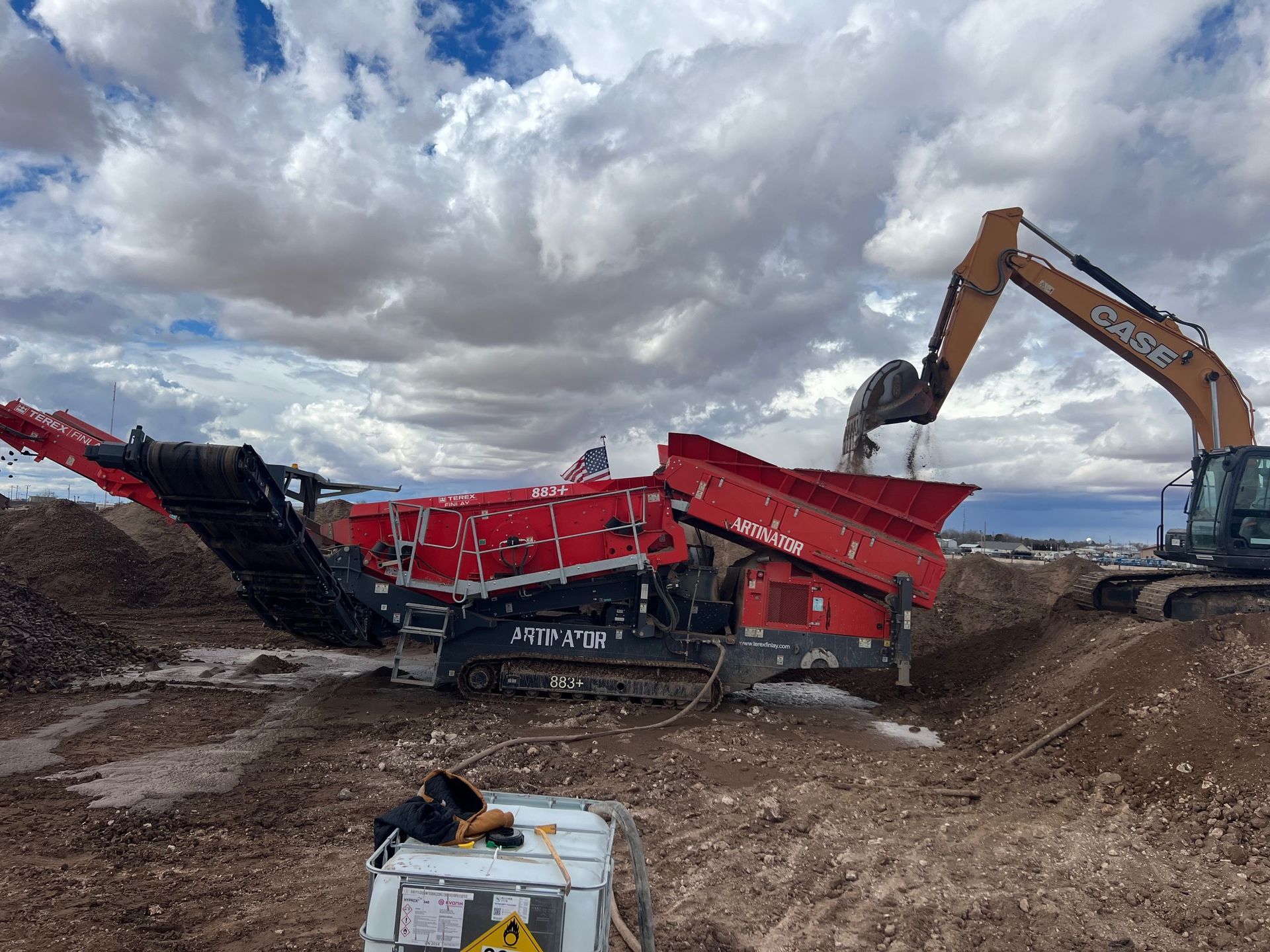 A large excavator is digging a hole in the dirt.