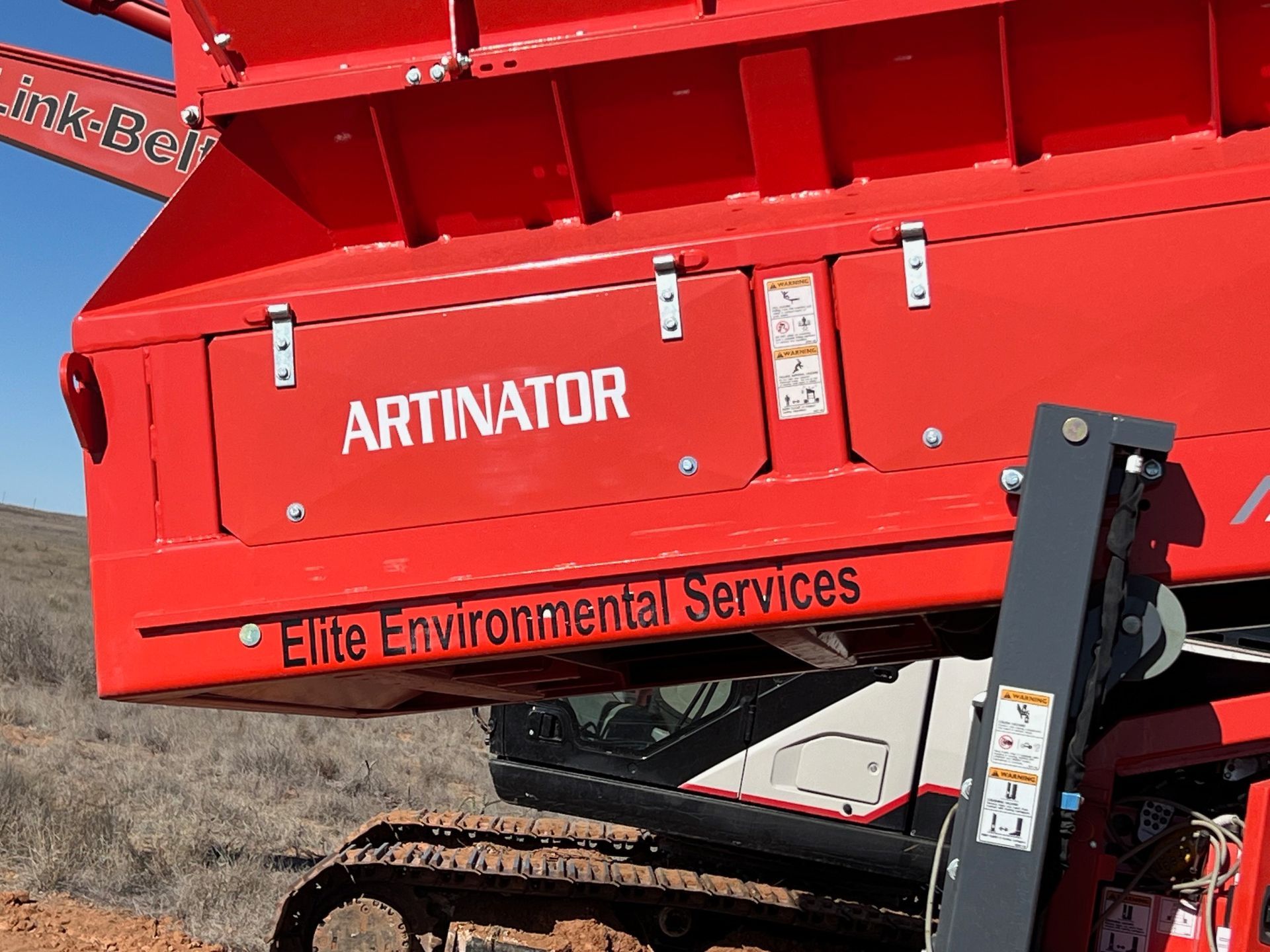 A red artinator with elite environmental services written on it