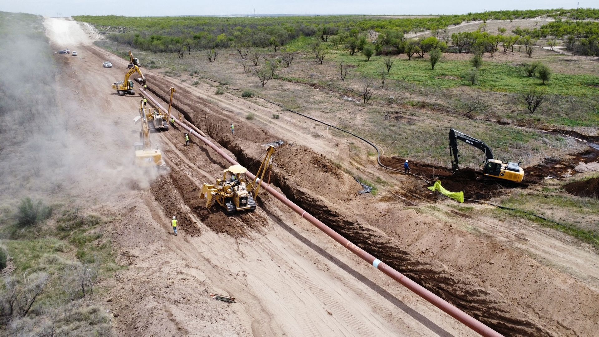 An aerial view of a construction site with a pipe being installed.