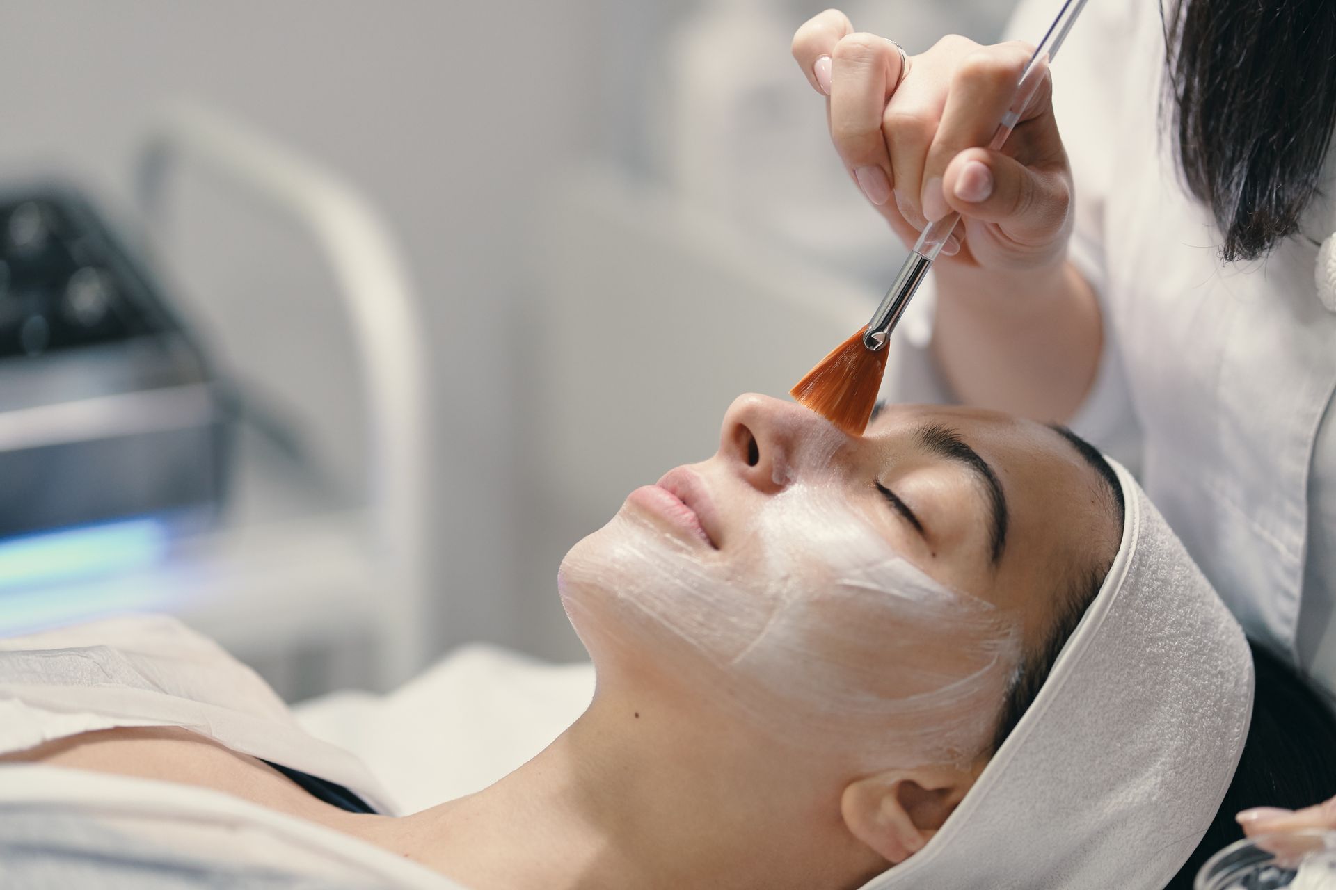 A woman is getting a facial treatment at a spa.