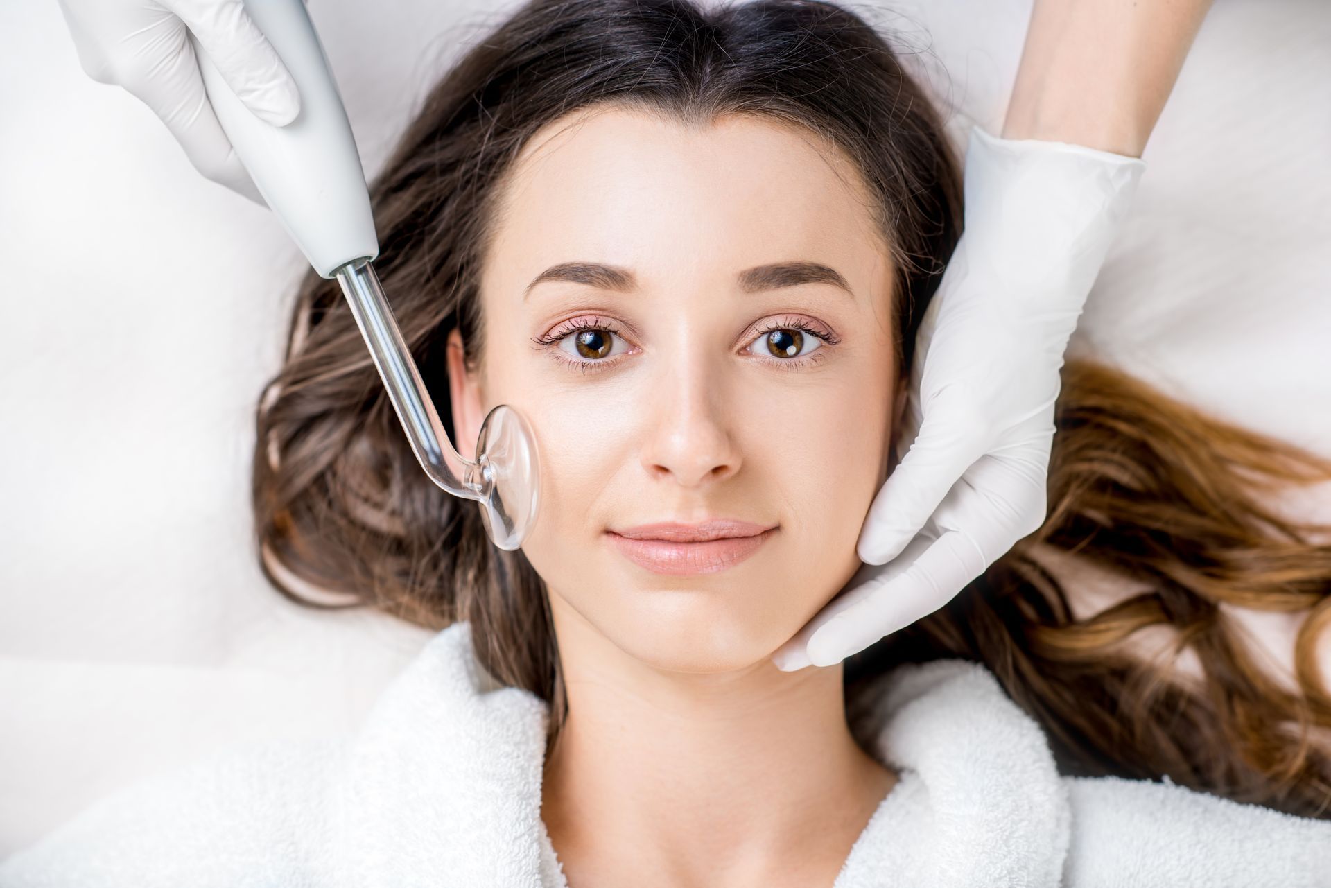 A woman is getting a facial treatment at a beauty salon.