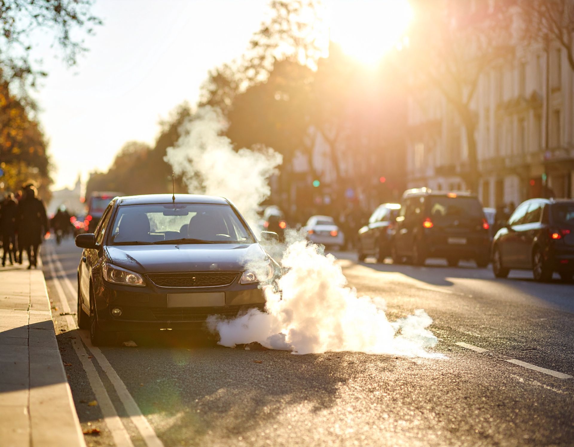 Broken down car on busy Central London road with hazard lights on
