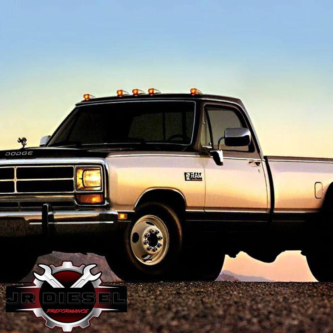 Classic Dodge Ram dually pickup truck, white and black, with sunset background and JR Diesel logo.