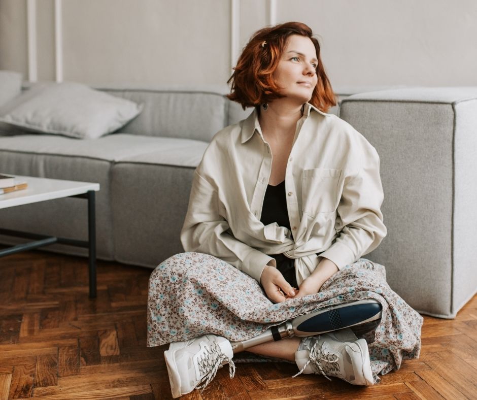 An NDIS participant relaxing in a modern, non-clinical living space that features custom-designed accessibility, visually validating the promise of regaining independence in a safe, stable home through tailored Specialist Disability Accommodation (SDA).