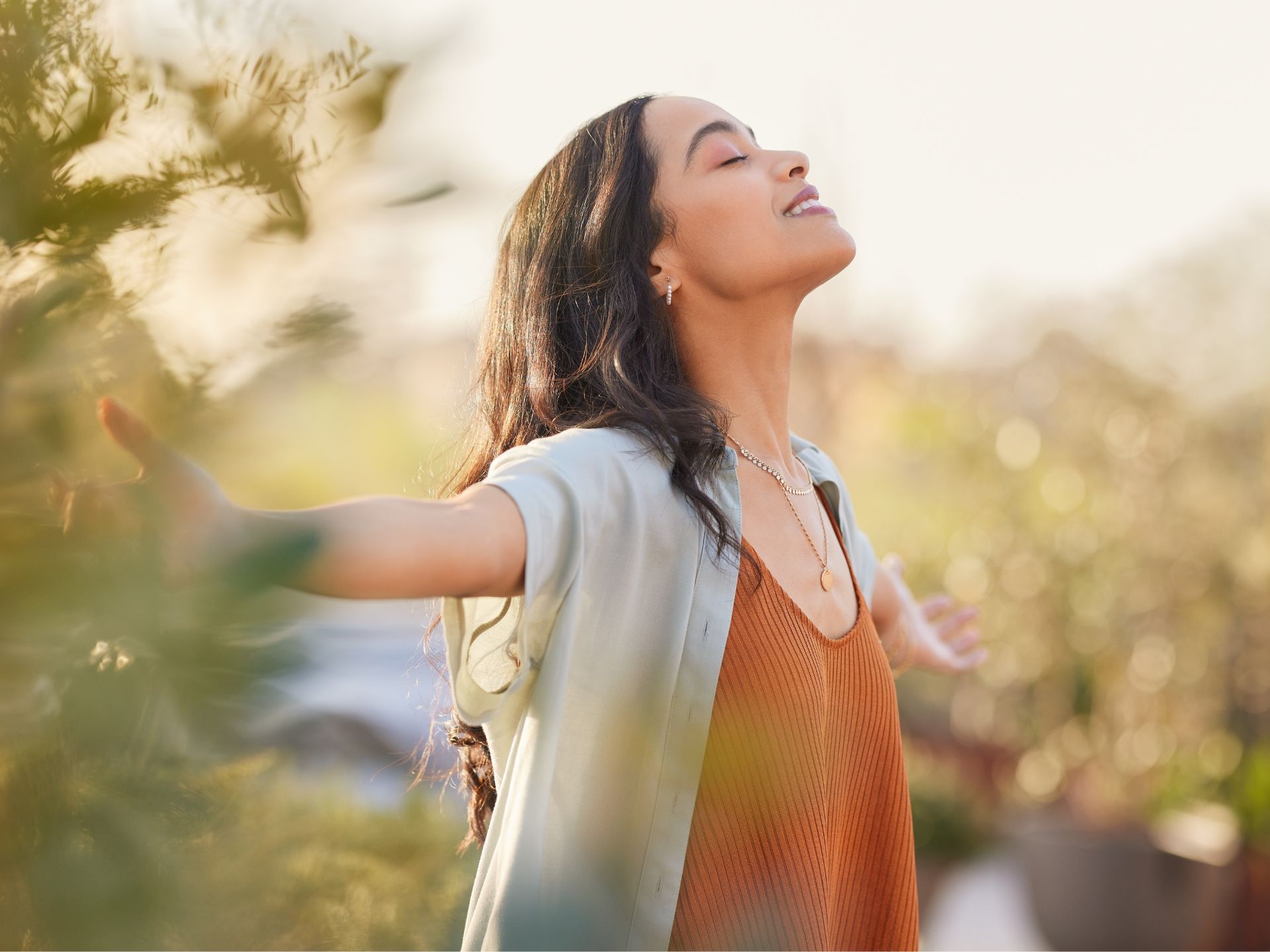A young woman enjoying the outdoors, representing the holistic health care and mental health strategies integrated into Plan and Grow's support services.