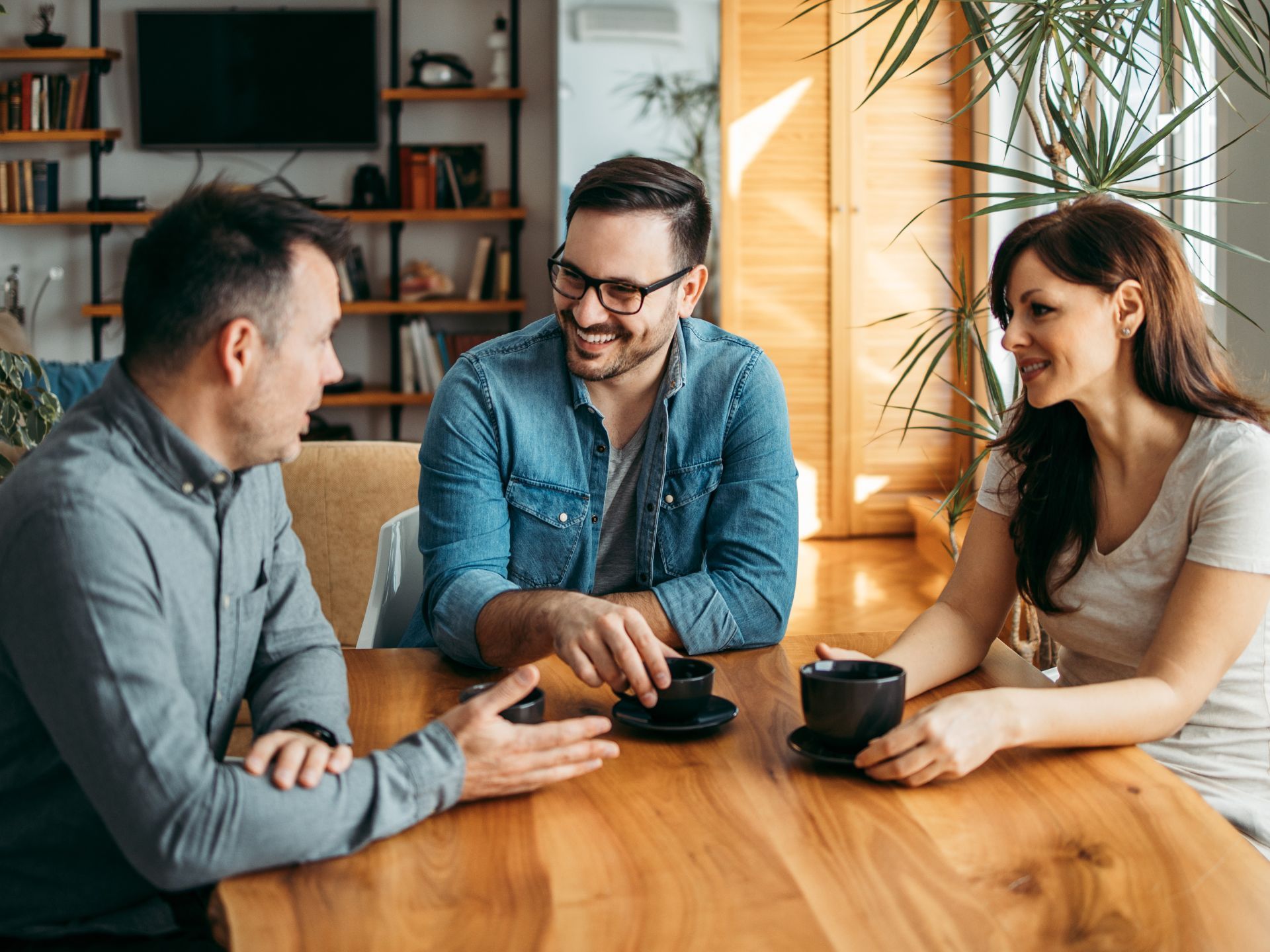 A support worker and participant discussing goals at a table, illustrating the ongoing NDIS support and holistic care provided to foster long-term community living.