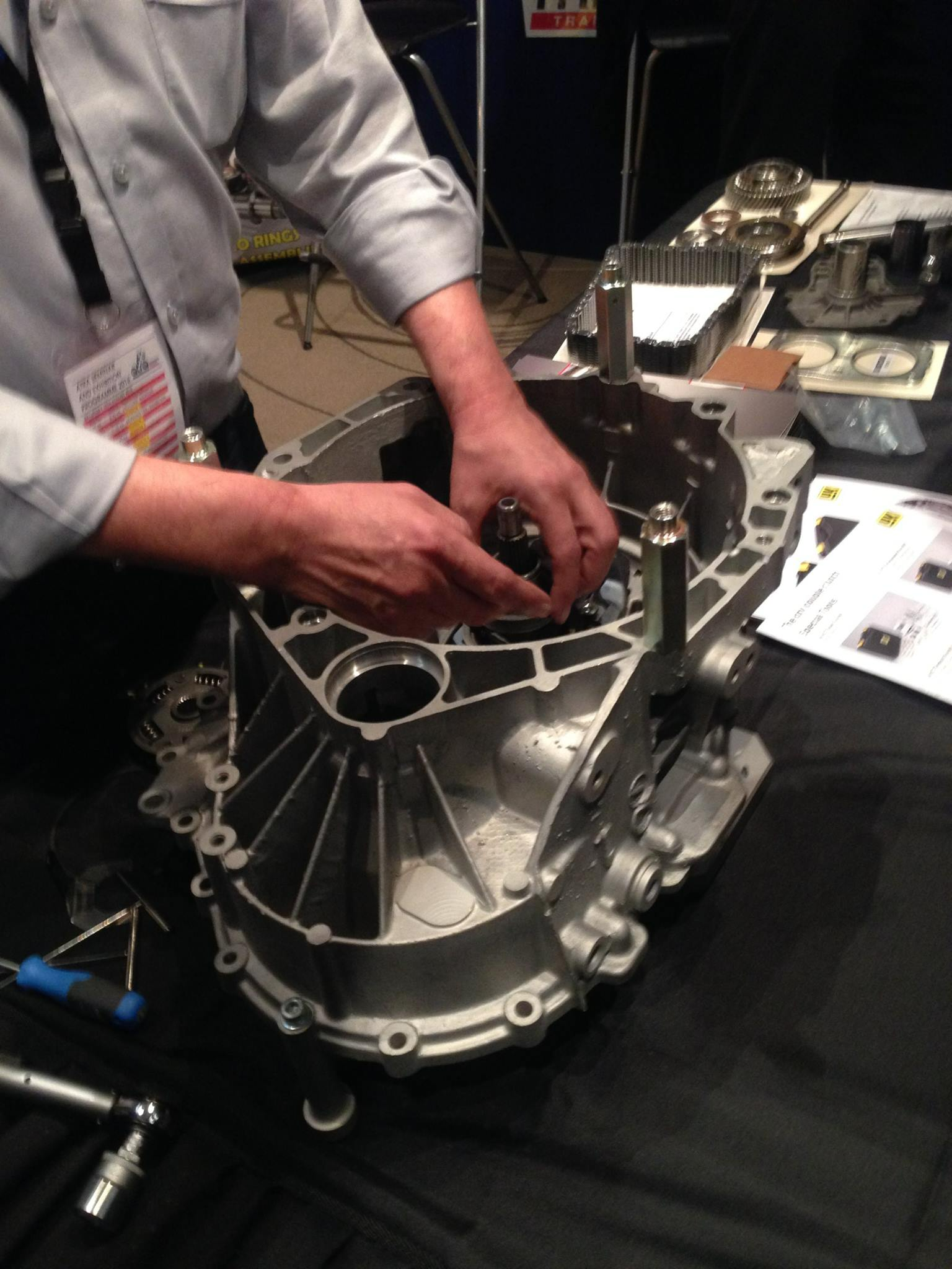 A Man Is Working On A Piece Of Metal On A Table — Town Automatics 4WD & Mechanical in South Townsville, QLD