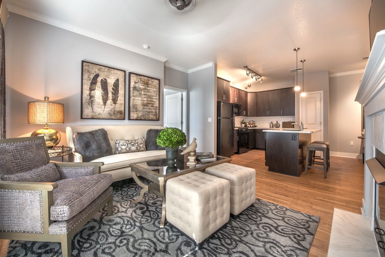 Open-concept living room with seating area, coffee table, and a kitchen island.