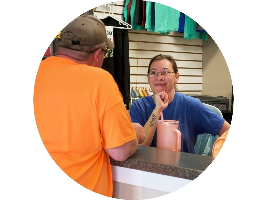 A group of people standing next to each other in a circle.