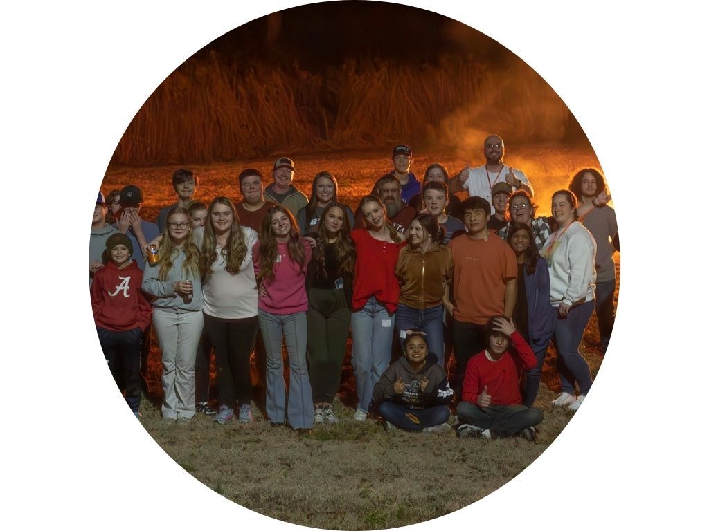 A group of people are sitting in a circle in an auditorium.