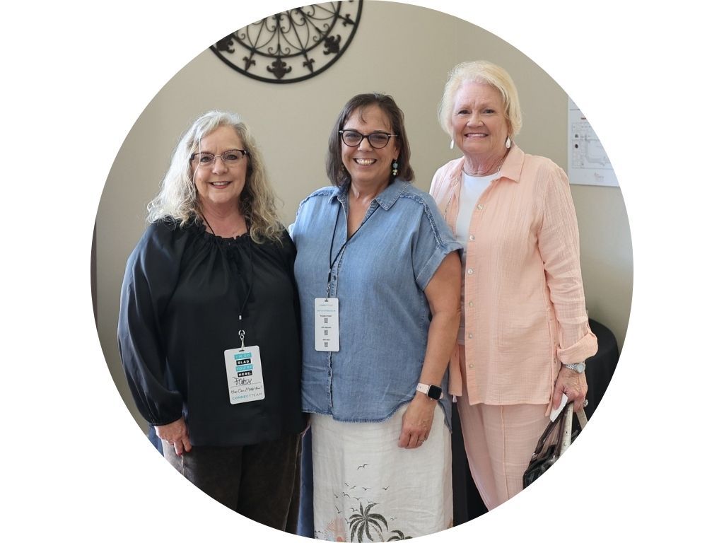 A group of people standing next to each other in a circle.