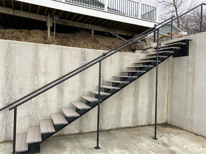 A set of stairs leading up to a concrete wall.