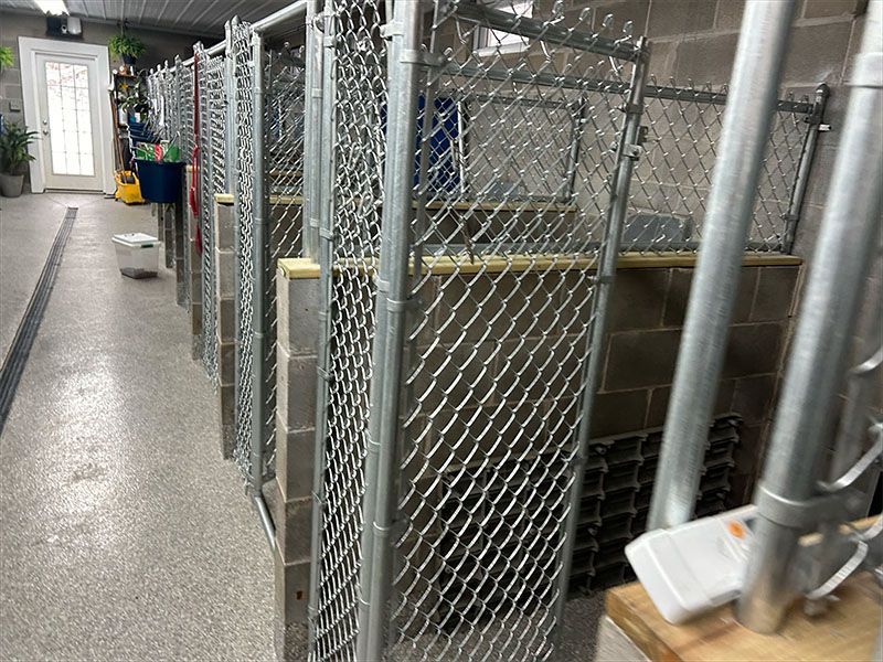 A row of chain link fences are lined up in a room.