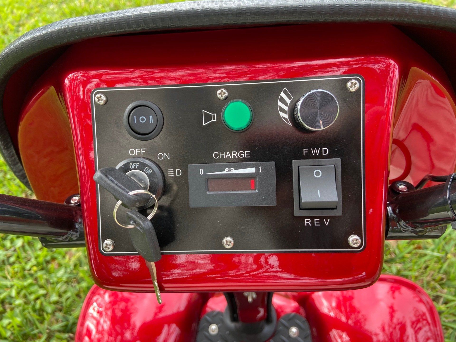 A close up of a red atv with a dashboard