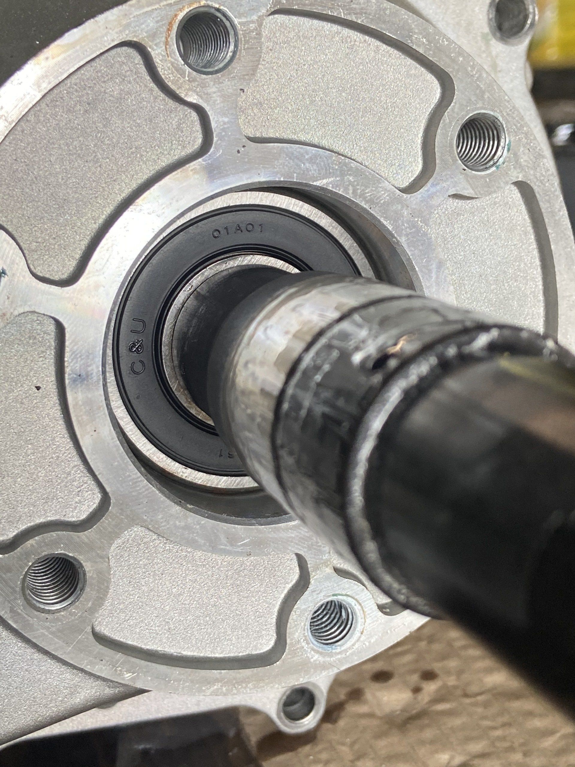 A close up of a metal object with a bearing on it.