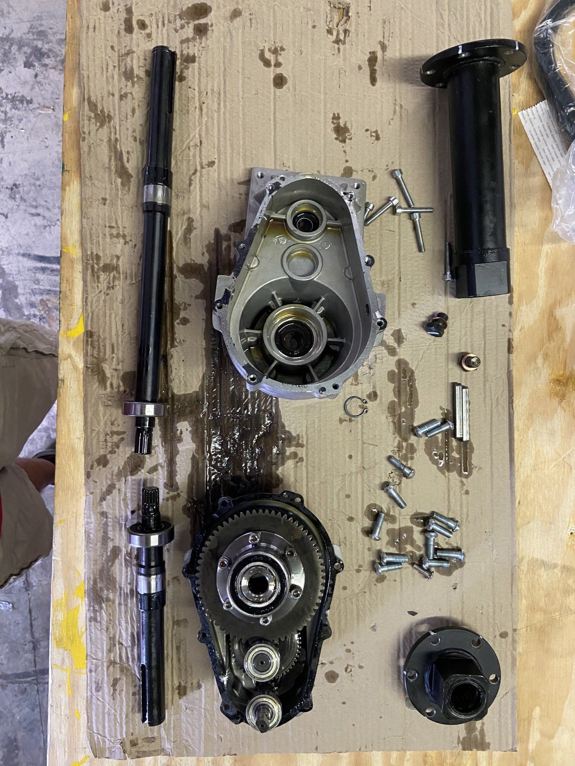 A bunch of parts are laying on a wooden table.