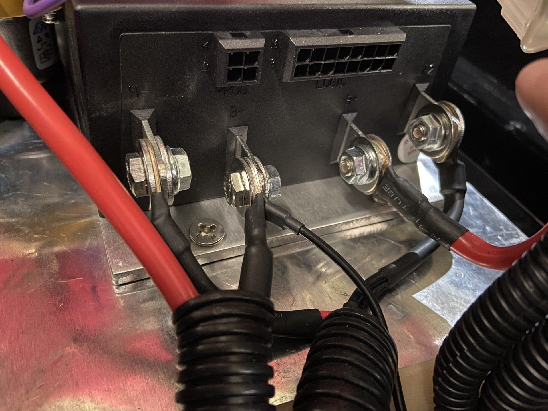 A close up of a fuse box with wires attached to it