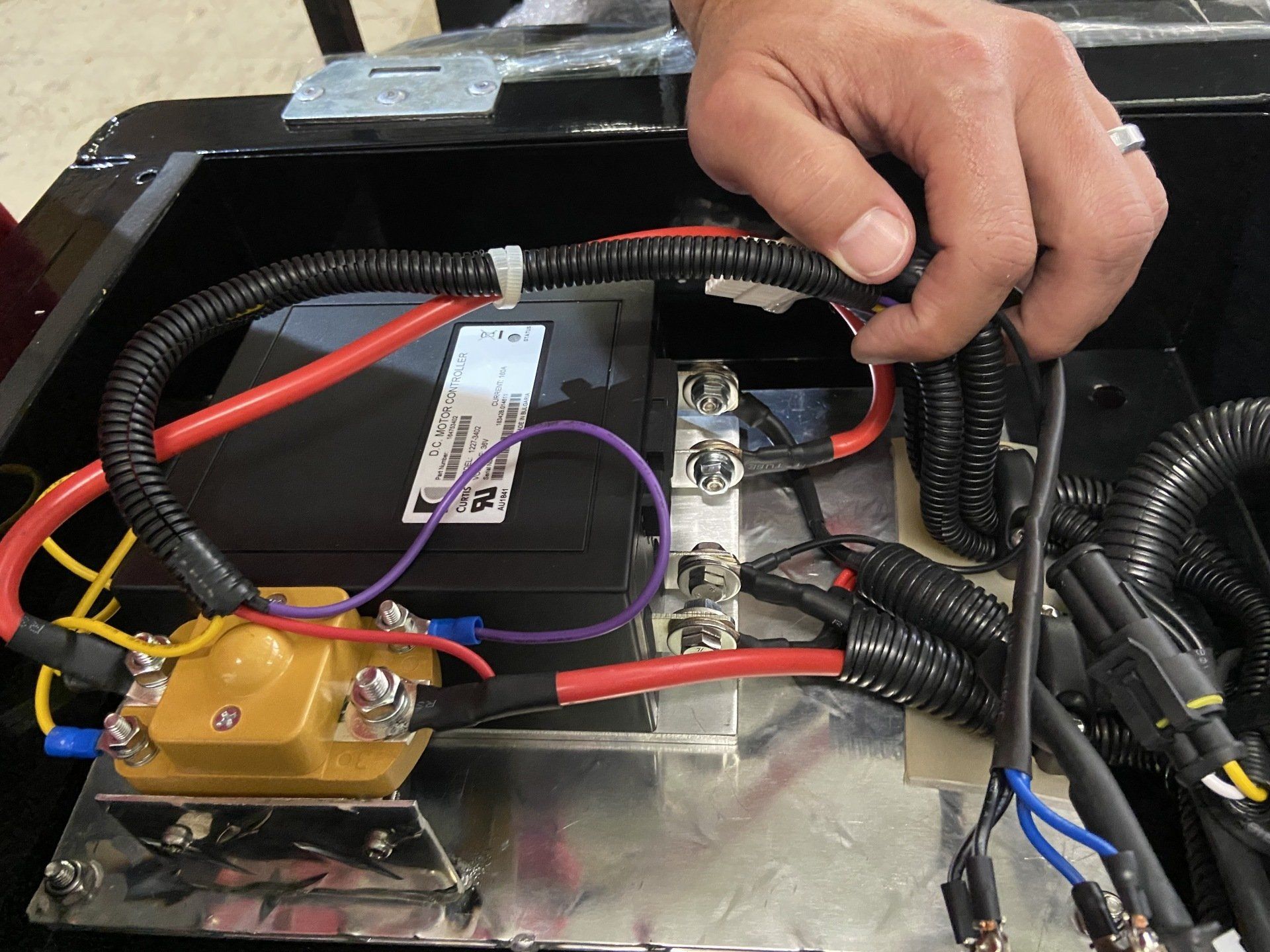 A close up of a person working on wires in a box