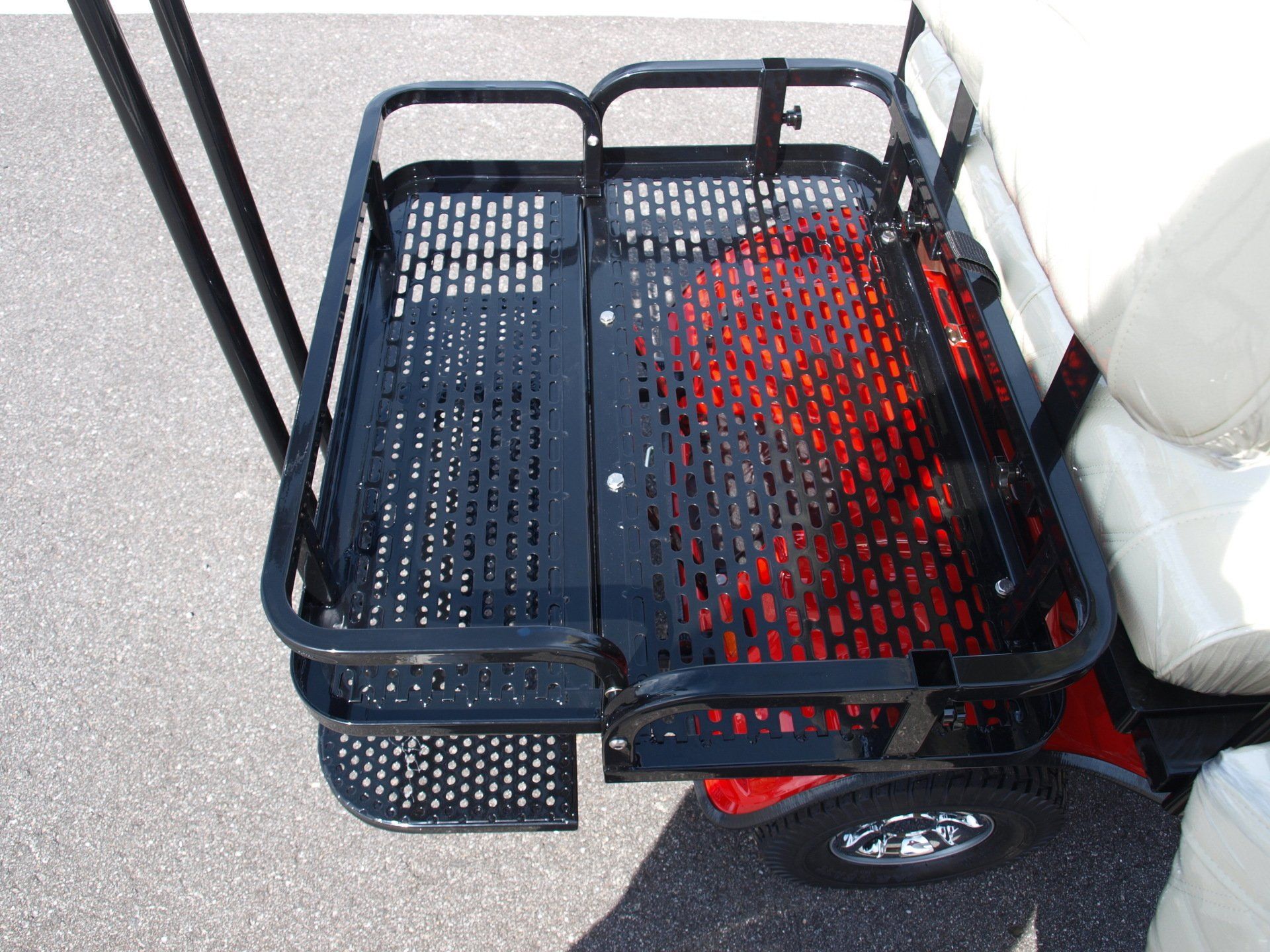 The back of a golf cart with a basket attached to it.