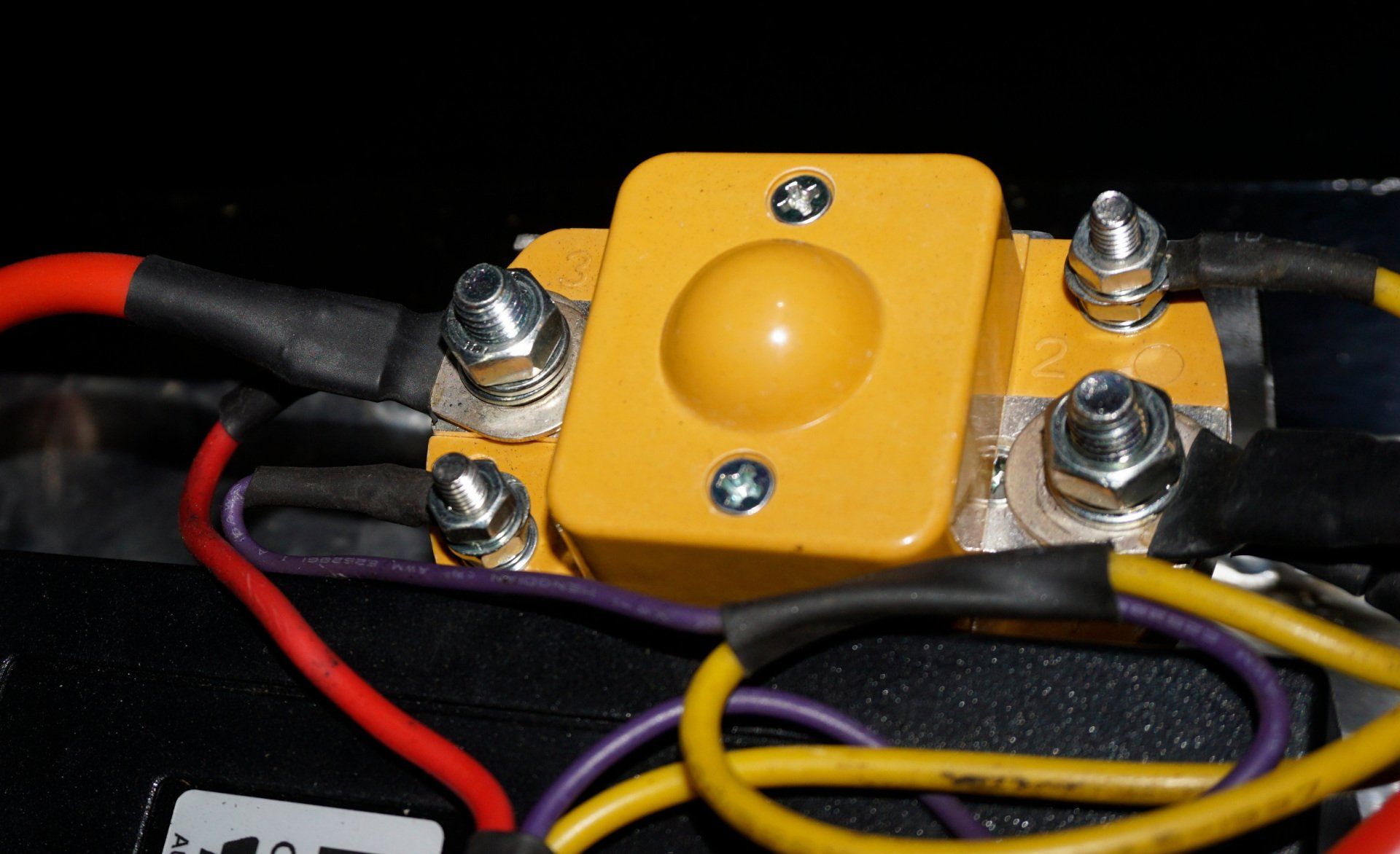 A bunch of wires are connected to a yellow box