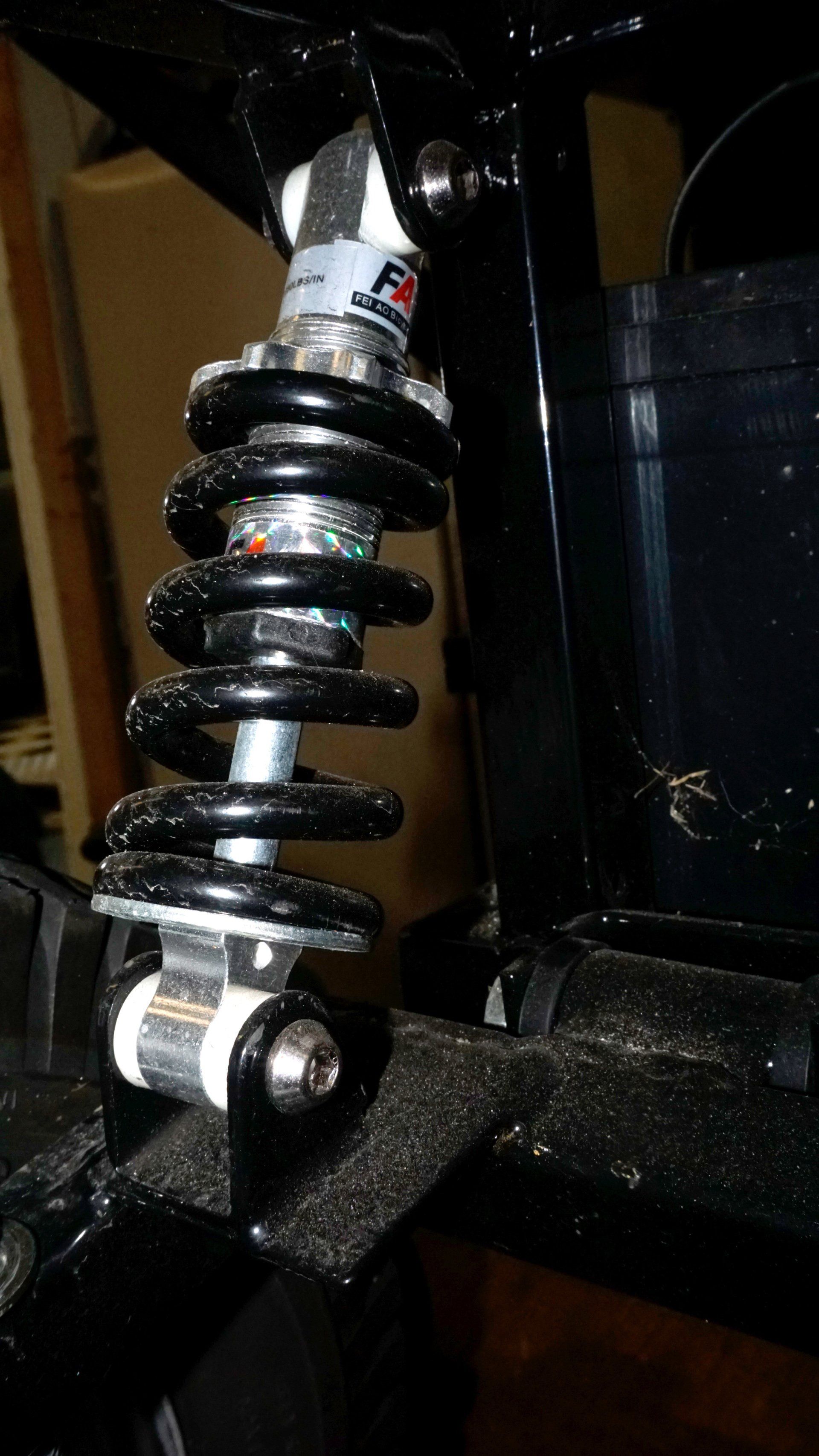 A close up of a shock absorber on a bicycle.