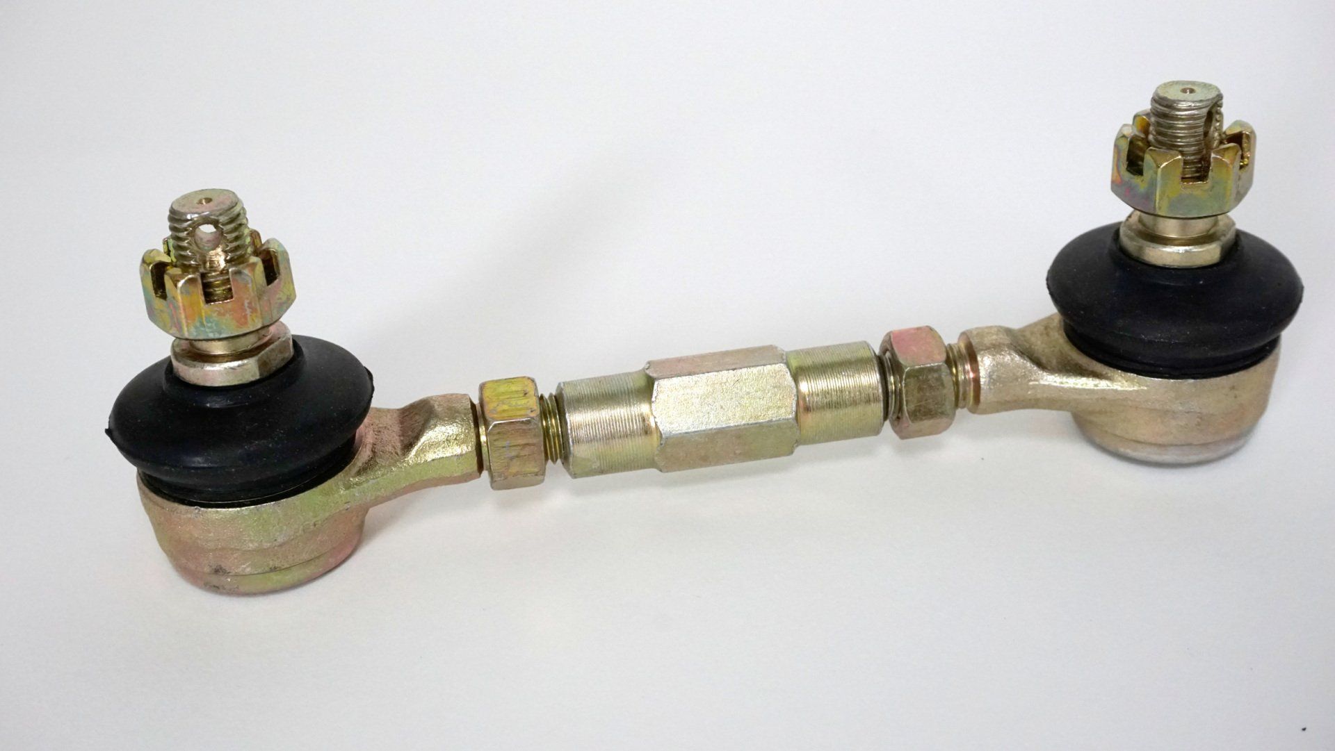 A close up of a tie rod on a white surface.