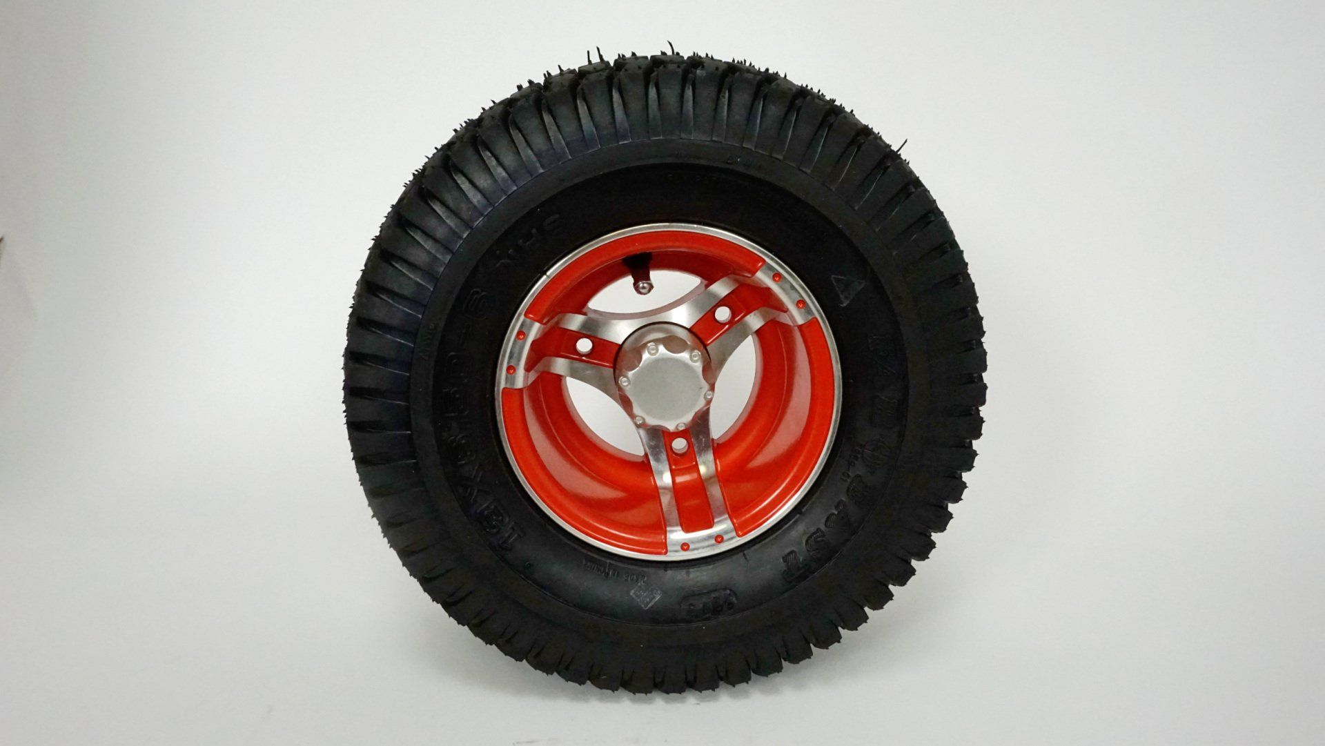 A close up of a tire with a red rim