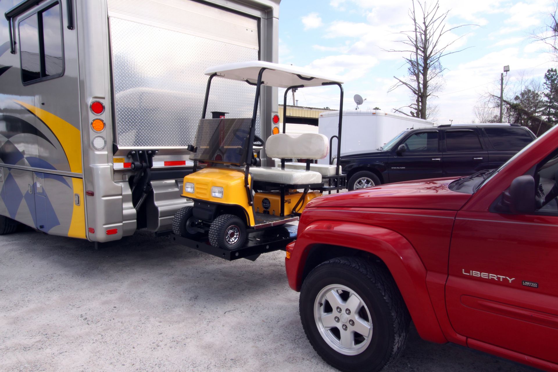 A red truck is parked next to a golf cart
