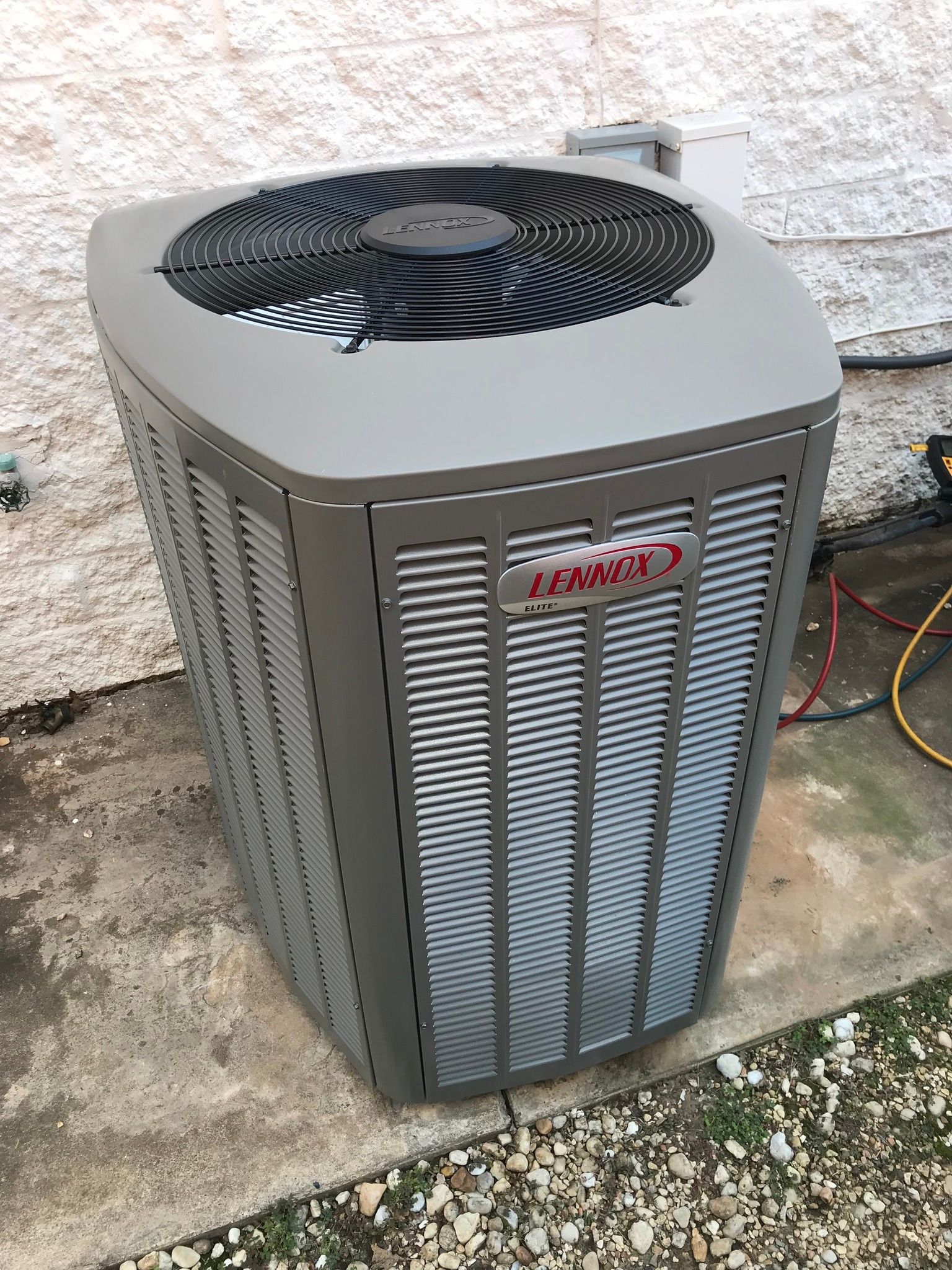 Gray Lennox air conditioning unit outside a building.