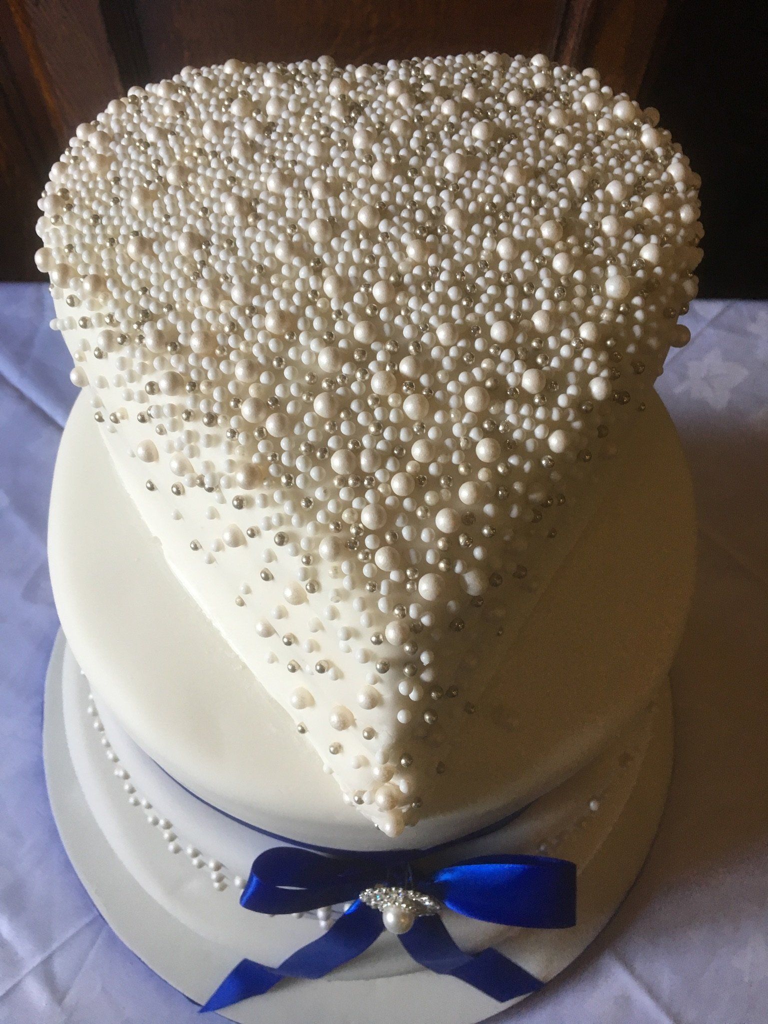 heart wedding cake with blue bow