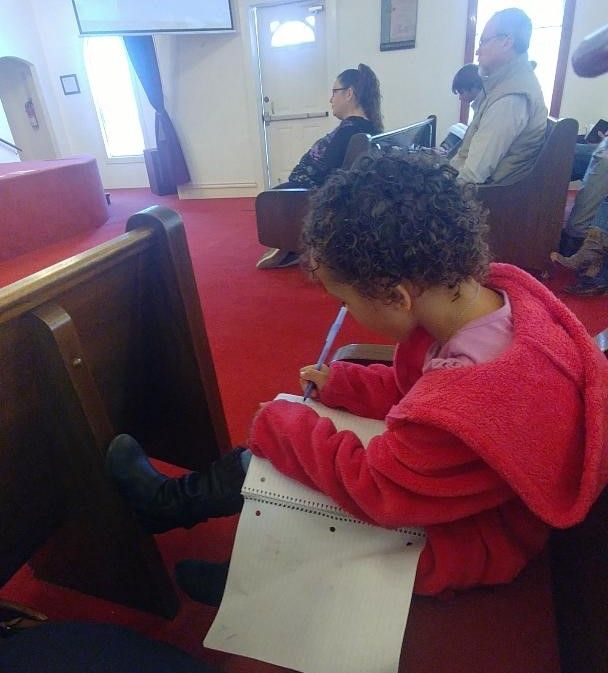 Young Girl Drawing in Church