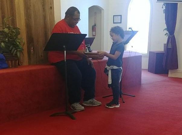 Pastor Showing Child Bible