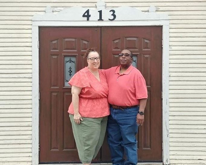 Husband and Wife Standing at Church Entrance