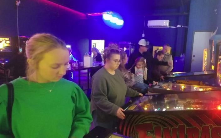 Teenagers Playing Pinball