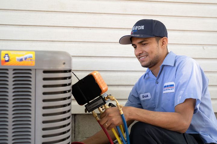 Trained technician fixing outside AC unit