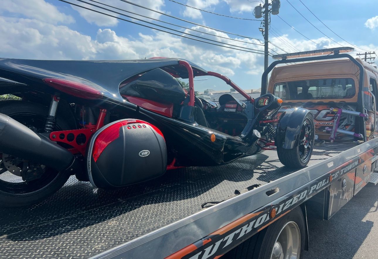 A motorcycle is sitting on top of a tow truck.