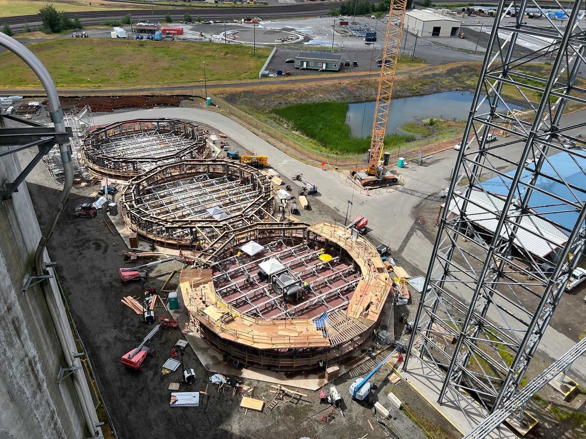 An aerial view of a construction site with a crane in the background.