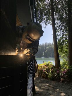 A man wearing a welding mask is welding a piece of metal.