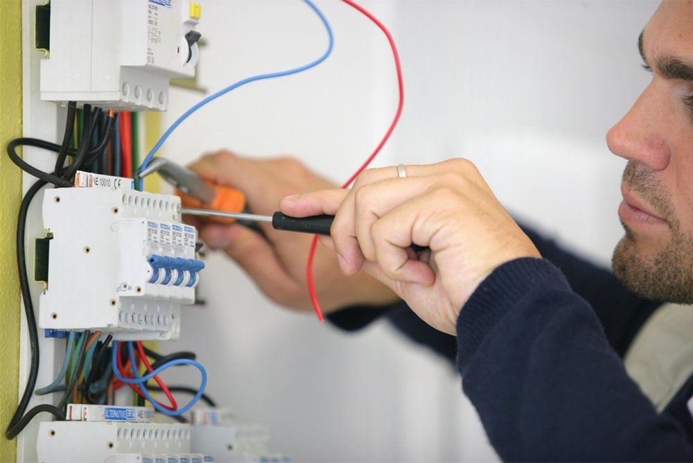 Man working on a circuit breaker