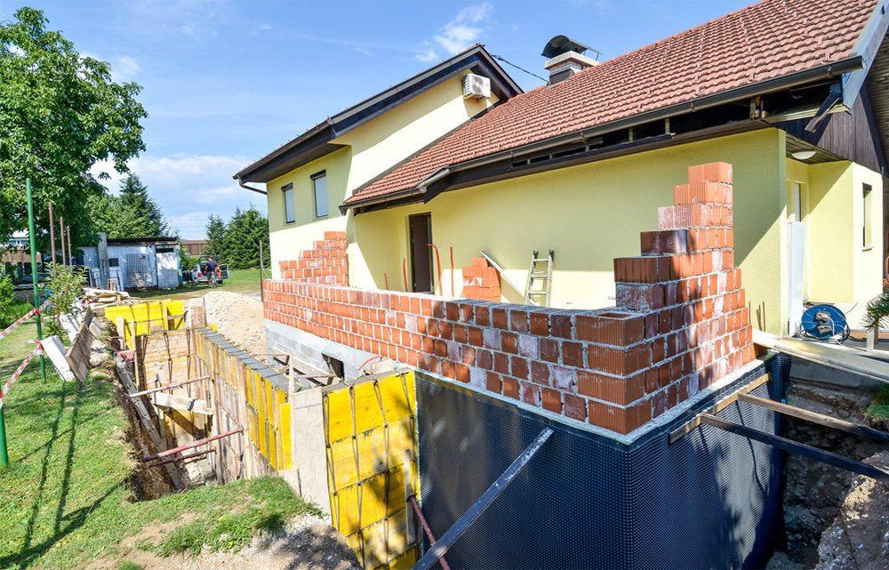 Rebuilding a family house and adding an extension. Setting up a construction site with formwork..
