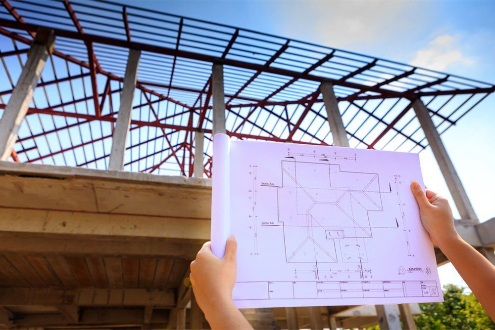architecture drawings in hand on house building