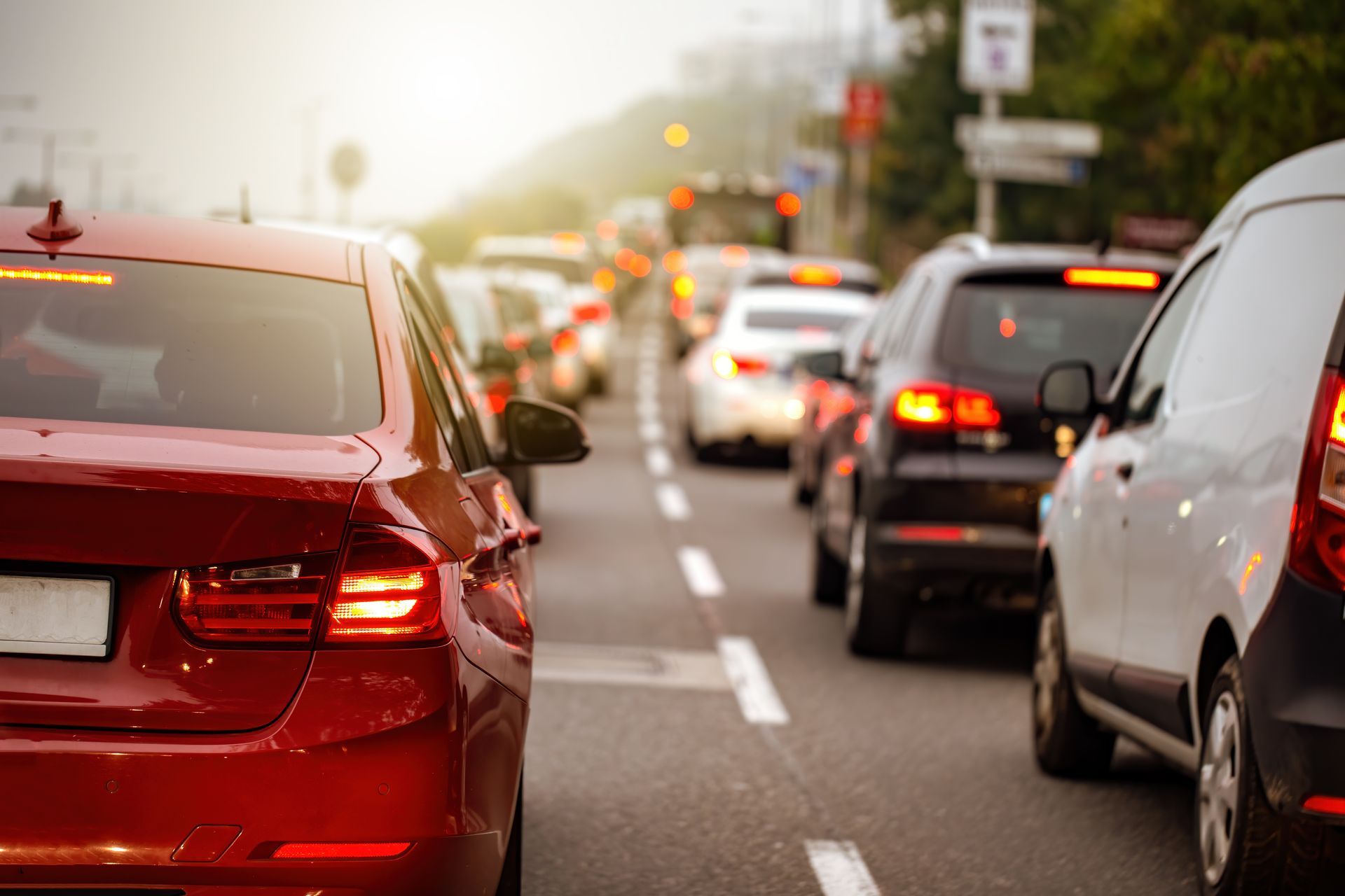 Traffic jam on a multi-lane road; red car in foreground.