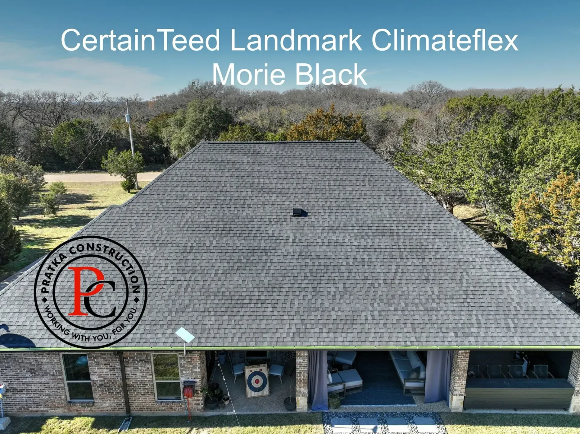 Aerial view of a house with black shingle roof. The text above the roof says 