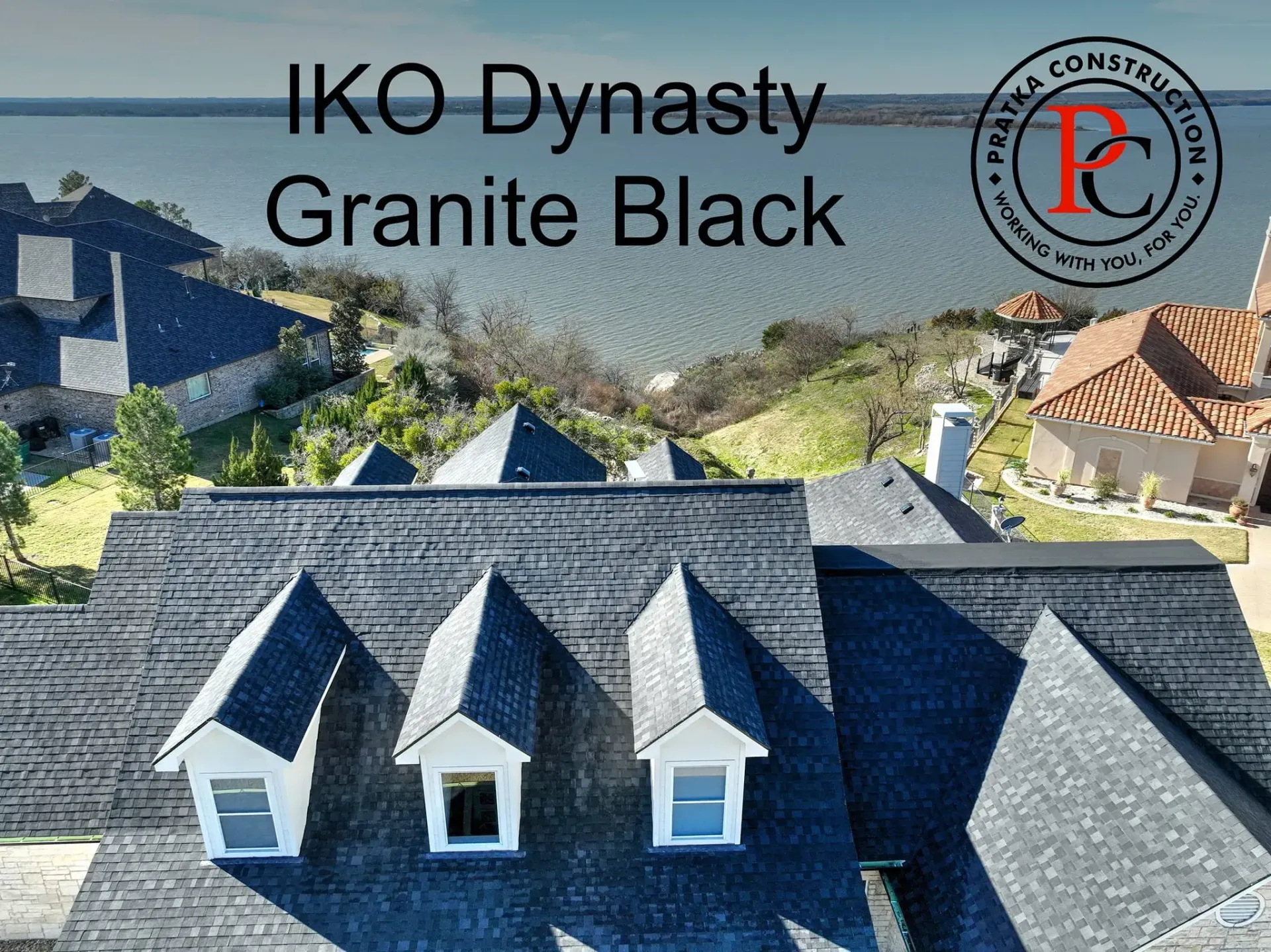 Black shingled roof with dormers, Granite Black IKO Dynasty, by the water.