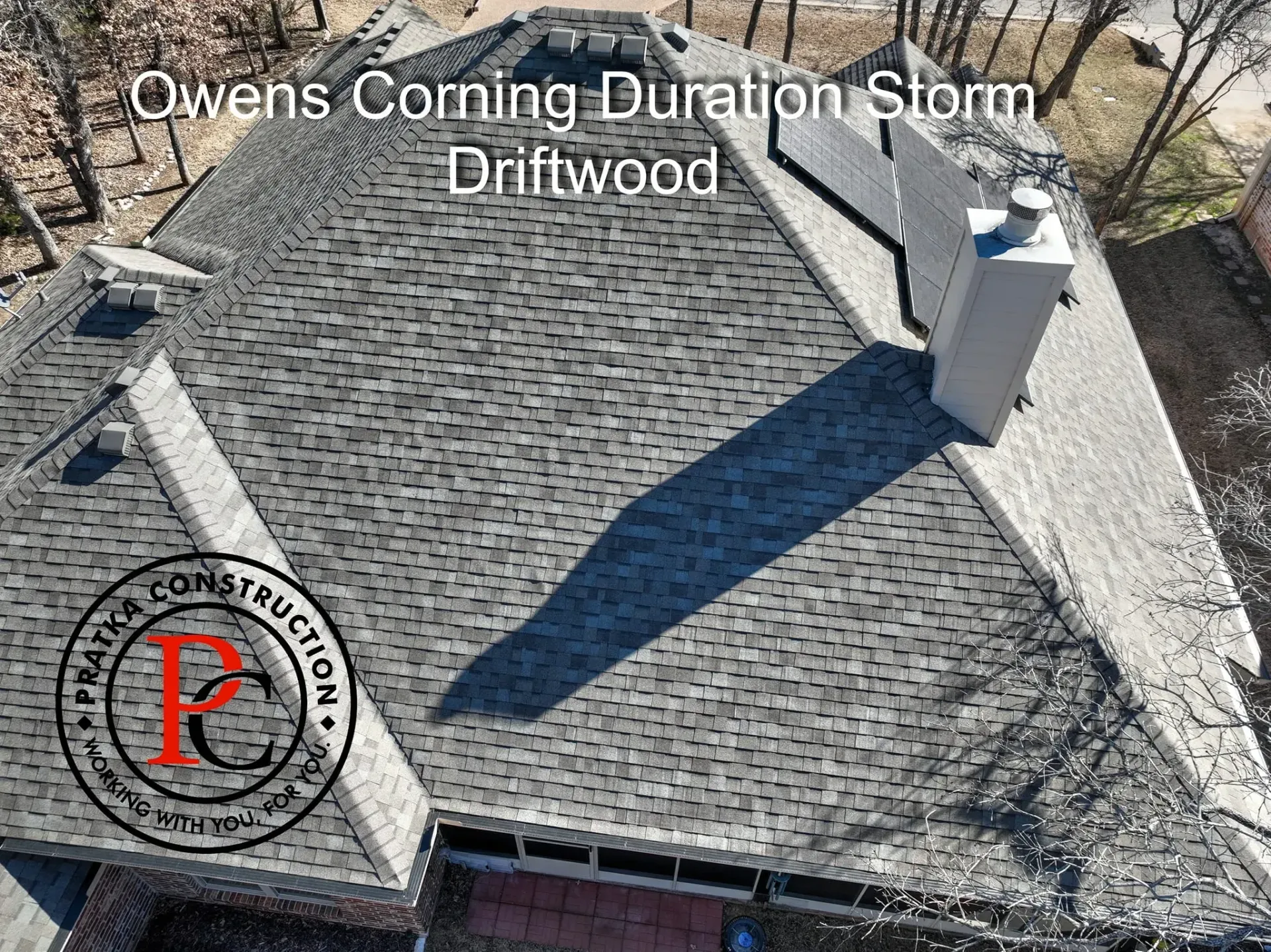 Overhead view of a roof with Owens Corning Duration Storm Driftwood shingles, white chimney, and the 