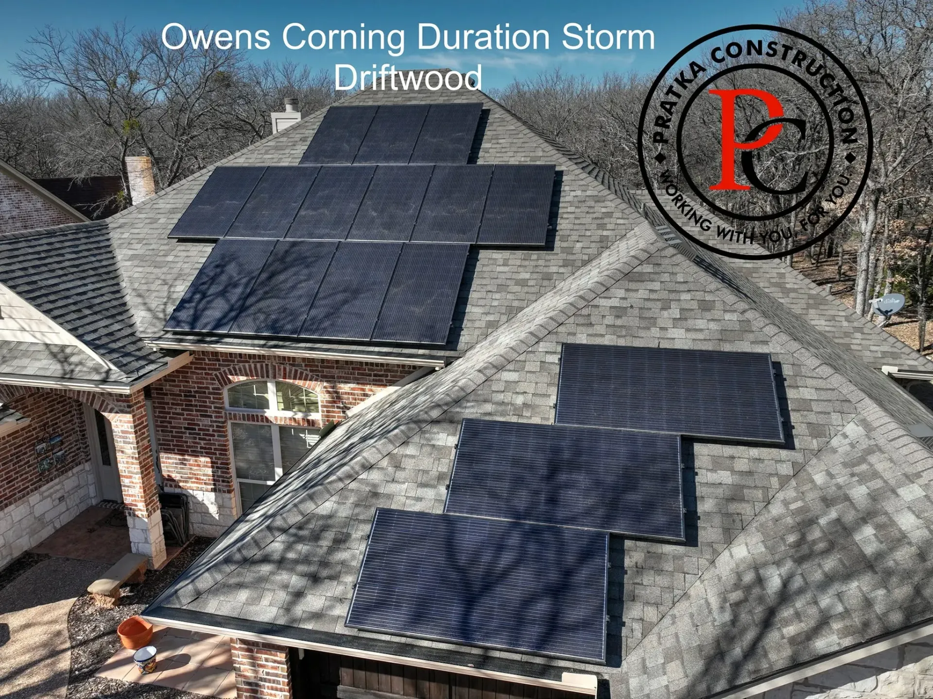 Solar panels on a house roof covered with Owens Corning Duration Storm Driftwood shingles.