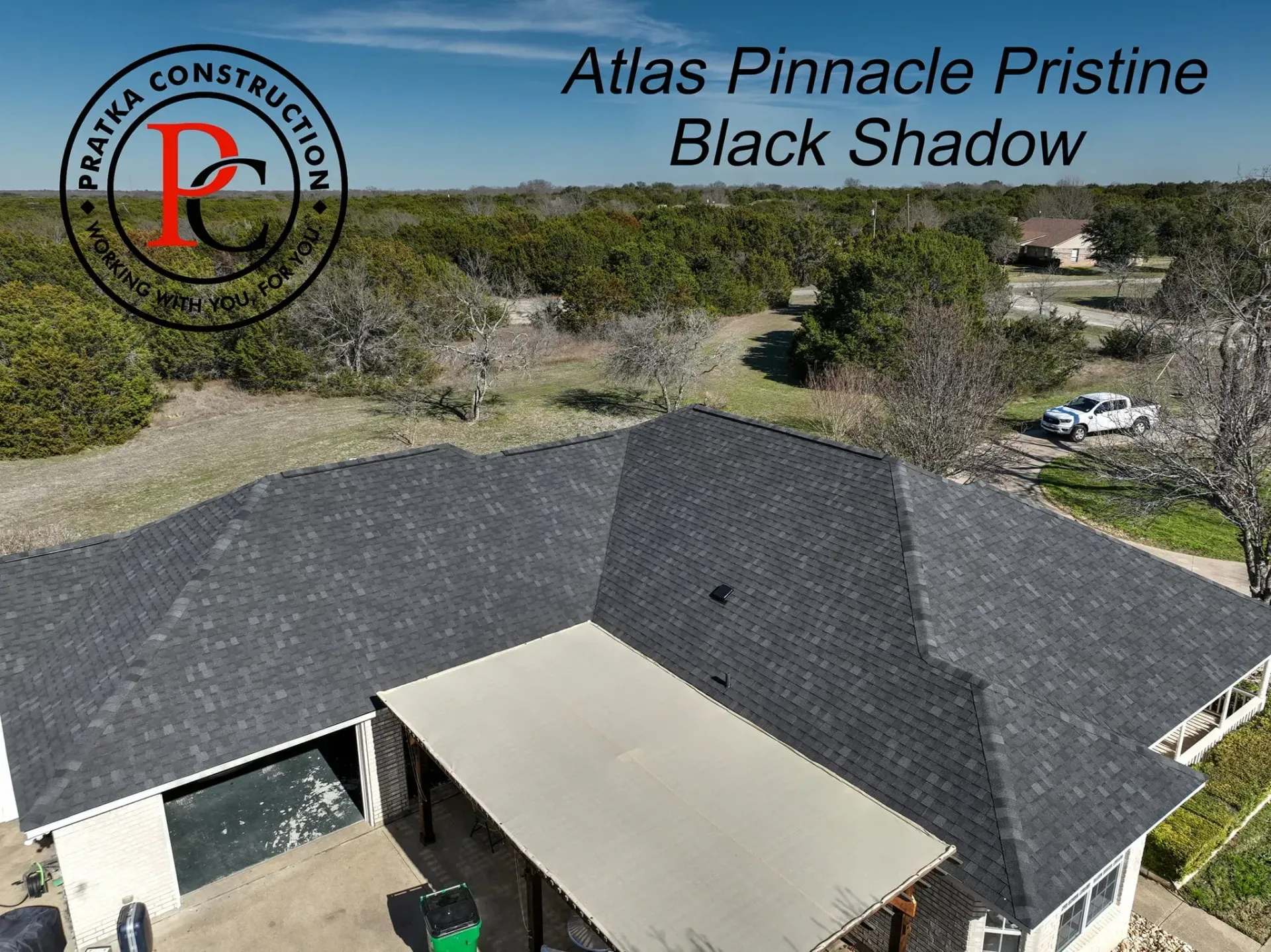 Overhead view of a house with a black shadow shingle roof.
