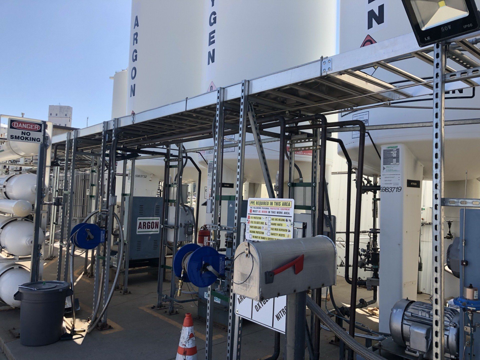 A mailbox is sitting in front of a gas station.