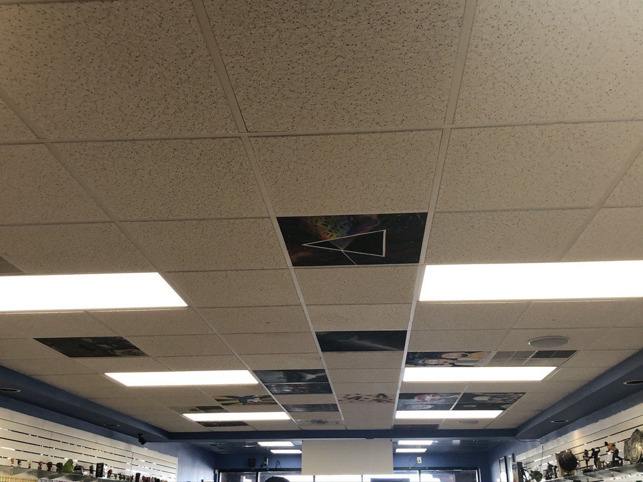 The ceiling of a store has a lot of lights on it